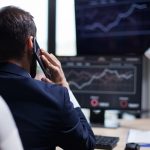 Back view of young business bearded man having a phone call with his CEO